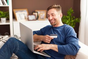 smiling-man-during-online-shopping-home